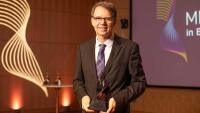 Michel Sadelain holding the Merkin Prize award.